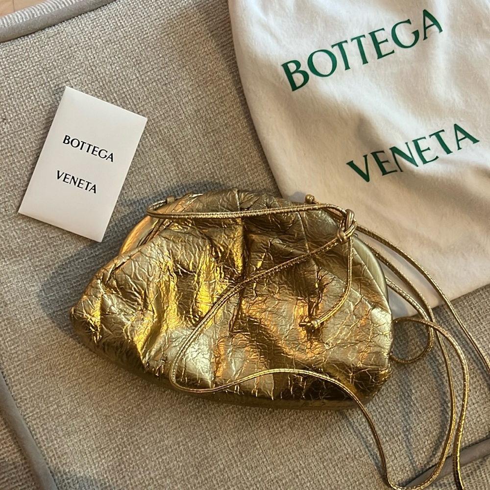 Small pouch gold color. Some faded gold towards top of bag. Clean interior.